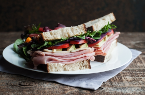 Thin sliced ham and vegetables on rustic crusty fresh country bread